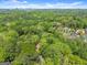 Beautiful aerial view featuring a grand home, manicured lawns, and mature trees in a quiet, wooded neighborhood at 3985 Randall Mill Nw Rd, Atlanta, GA 30327