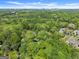 Scenic aerial view of property surrounded by a lush forest and the city skyline at 3985 Randall Mill Nw Rd, Atlanta, GA 30327