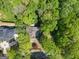 Aerial view shows the property surrounded by lush greenery and mature trees at 3985 Randall Mill Nw Rd, Atlanta, GA 30327