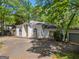 Attractive exterior showcasing the house with white stucco facade, arched details, and attached garage at 3985 Randall Mill Nw Rd, Atlanta, GA 30327