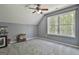 Attic space with carpet, gray walls, vaulted ceilings, and a window at 49 Moss Cts, Palmetto, GA 30268