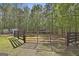 Fenced backyard with mature trees and a wooded perimeter offers privacy at 49 Moss Cts, Palmetto, GA 30268