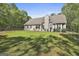 Expansive backyard with a well-maintained lawn, patio, and partial fencing for privacy at 49 Moss Cts, Palmetto, GA 30268