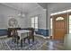 Dining room with table, chandelier, and large window letting in lots of natural light at 49 Moss Cts, Palmetto, GA 30268