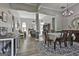 Spacious dining room with chandelier, decorative rug and open to living area at 49 Moss Cts, Palmetto, GA 30268