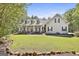 Inviting two-story home with a spacious front porch, well-manicured lawn, and charming curb appeal at 49 Moss Cts, Palmetto, GA 30268