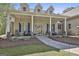 Charming front porch with comfortable seating, decorative planters, and welcoming curb appeal at 49 Moss Cts, Palmetto, GA 30268