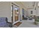 Charming front porch sitting area with cozy wicker chairs and covered entry at 49 Moss Cts, Palmetto, GA 30268