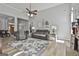 Relaxing living room features neutral colors, a ceiling fan, and a cozy seating area at 49 Moss Cts, Palmetto, GA 30268