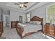Spacious main bedroom featuring a tray ceiling, wooden furniture set, and plush gray carpet at 49 Moss Cts, Palmetto, GA 30268