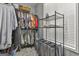 Organized walk-in closet with shelving, hanging racks, laundry bins, and a window for natural light at 49 Moss Cts, Palmetto, GA 30268