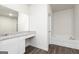 Bathroom featuring a vanity with granite countertop and a soaking tub at 271 Oliver Dr, Locust Grove, GA 30248