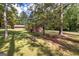 Shaded backyard with mature trees and a detached brick building on a well-maintained lawn at 8289 Lake View Ter, Riverdale, GA 30274