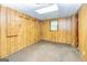 Finished basement featuring wood-paneled walls, closet, and window at 8289 Lake View Ter, Riverdale, GA 30274