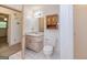 Bathroom featuring a toilet, vanity, mirror, shower, and a doorway to another room at 8289 Lake View Ter, Riverdale, GA 30274