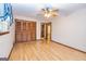 Bedroom featuring hardwood floors, a ceiling fan, and closet with folding wood doors at 8289 Lake View Ter, Riverdale, GA 30274