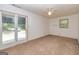 Bedroom featuring carpet, one window, sliding glass doors, and a ceiling fan at 8289 Lake View Ter, Riverdale, GA 30274