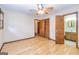 Spacious bedroom featuring hardwood floors, a ceiling fan, and access to an ensuite bathroom at 8289 Lake View Ter, Riverdale, GA 30274