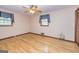 Bright bedroom with hardwood floors, a ceiling fan, and natural light from the two windows at 8289 Lake View Ter, Riverdale, GA 30274