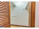 View of a walk-in closet featuring wood bi-fold doors and custom shelving at 8289 Lake View Ter, Riverdale, GA 30274