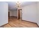 Well lit dining area with chandelier, hardwood floors, and open floor plan at 8289 Lake View Ter, Riverdale, GA 30274
