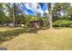 Back view of a two story brick home with mature trees at 8289 Lake View Ter, Riverdale, GA 30274