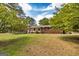 Two story house with brick and siding, black shutters, and mature trees at 8289 Lake View Ter, Riverdale, GA 30274