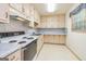 Kitchen features light colored cabinets, white appliances, and a window at 8289 Lake View Ter, Riverdale, GA 30274