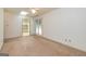Living room with carpet, a ceiling fan, and a view into the bathroom at 8289 Lake View Ter, Riverdale, GA 30274