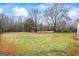 Vast backyard, enclosed by a fence, blends manicured lawn with natural growth, providing a peaceful retreat at 115 Stewart Hollow Ln, Covington, GA 30016