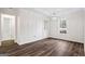 Bright bedroom features hardwood floors, a window, stylish light fixture and built in cabinets at 115 Stewart Hollow Ln, Covington, GA 30016