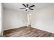 Bedroom with hardwood floors, a ceiling fan, and a double door closet offers ample storage space at 115 Stewart Hollow Ln, Covington, GA 30016