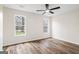Bedroom with hardwood floors has a ceiling fan, and two large windows at 115 Stewart Hollow Ln, Covington, GA 30016