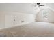 Spacious bonus room with carpeted floors, dormer windows, and ample natural light at 115 Stewart Hollow Ln, Covington, GA 30016
