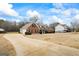 Sprawling home with a long driveway and ample parking space, surrounded by a lush yard at 115 Stewart Hollow Ln, Covington, GA 30016