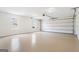 Spacious two car garage with sealed concrete flooring, two windows, and an automatic garage door at 115 Stewart Hollow Ln, Covington, GA 30016