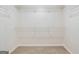 Walk-in closet with carpet and installed shelving provides ample storage space at 115 Stewart Hollow Ln, Covington, GA 30016