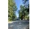 Street view showing mature trees, homes, and distant lake view at 2012 Lakeview Pkwy, Villa Rica, GA 30180