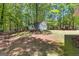 Backyard with trees surrounding a white building at 370 Merrydale Dr, Fayetteville, GA 30215