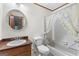 Bright bathroom with a floral shower curtain, wood vanity, and white toilet at 370 Merrydale Dr, Fayetteville, GA 30215