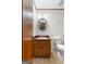 Bright bathroom featuring a round mirror above a wood vanity and a white toilet at 370 Merrydale Dr, Fayetteville, GA 30215