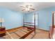 Spacious bedroom with light blue walls, ceiling fan, and wood furniture at 370 Merrydale Dr, Fayetteville, GA 30215