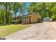 View of a single-story home with an attached two car garage and long driveway. Additional storage unit visible at 370 Merrydale Dr, Fayetteville, GA 30215