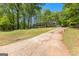 Sprawling single-story home with an extended driveway and lush landscaping, plus additional detached garage at 370 Merrydale Dr, Fayetteville, GA 30215