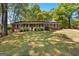 Charming single-story brick home with a cozy front porch, lush green lawn, and mature trees at 370 Merrydale Dr, Fayetteville, GA 30215