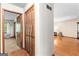 Hallway view showcasing closet space and hardwood floors at 370 Merrydale Dr, Fayetteville, GA 30215