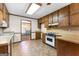Eat-in kitchen features wooden cabinets, tile floors, and a view into another room at 370 Merrydale Dr, Fayetteville, GA 30215