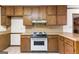 Traditional kitchen featuring wooden cabinets and a white electric range oven for a classic cooking experience at 370 Merrydale Dr, Fayetteville, GA 30215