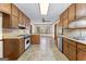 Functional kitchen featuring wood cabinetry, tiled floors, and modern appliances at 370 Merrydale Dr, Fayetteville, GA 30215