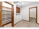 Practical laundry room with washer, dryer, and shelving for organized storage solutions at 370 Merrydale Dr, Fayetteville, GA 30215